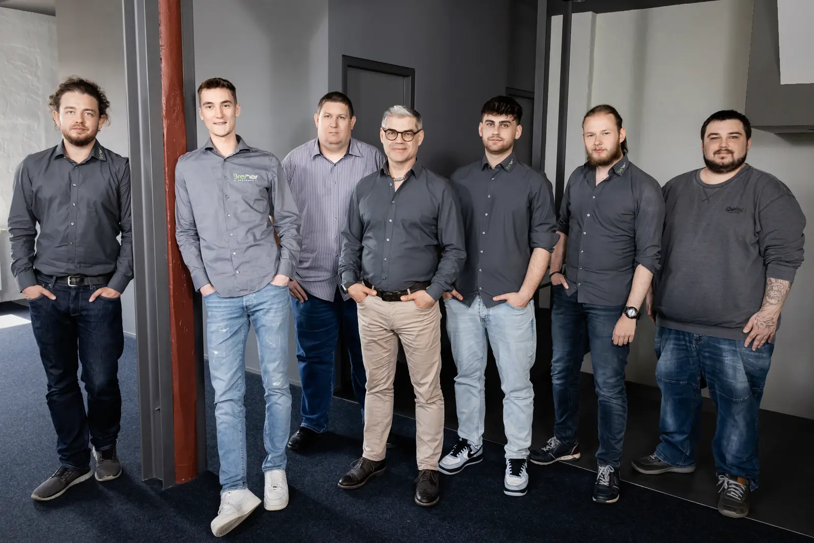 Das Team von BREiHOF iT steht gemeinsam im Büro in Heidelberg.